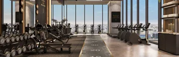 The gym, with treadmills facing floor-to-ceiling windows