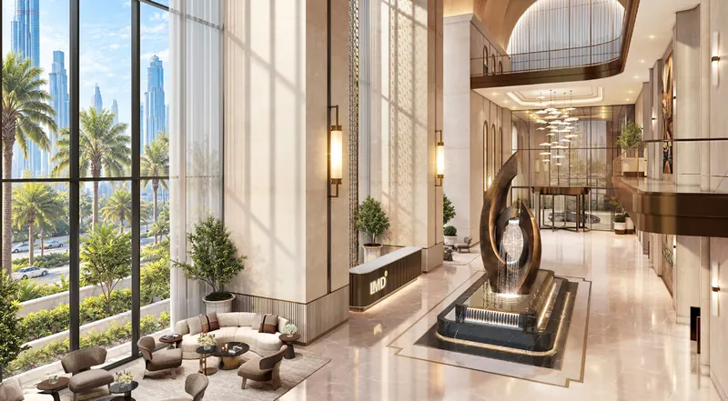 The triple-height arrival lobby with a bronze water sculpture and palm-lined windows onto Sheikh Zayed Road